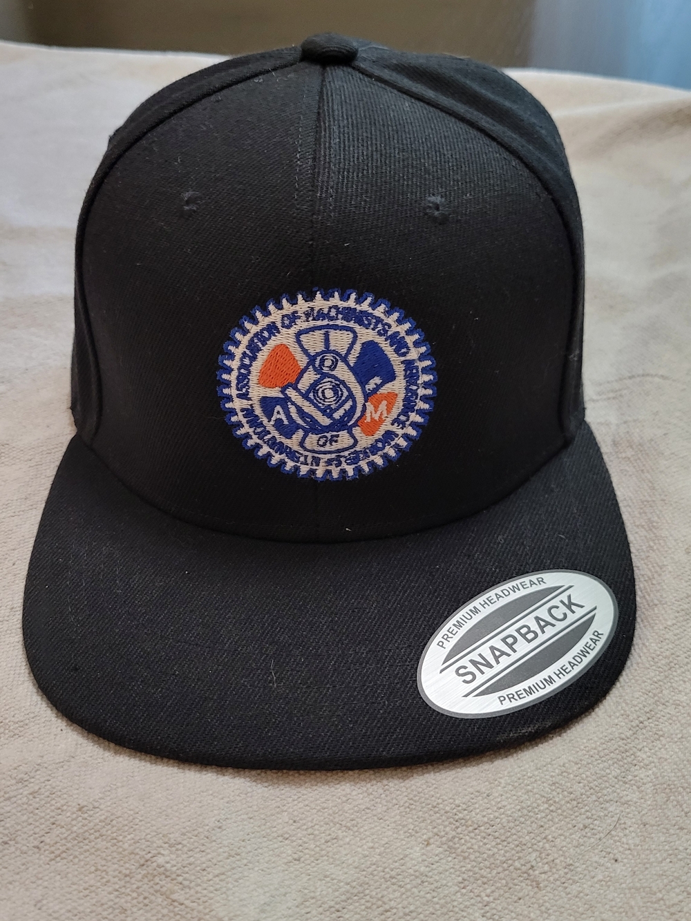 Black Snapback Hat with Embroidered Union Crest Patch